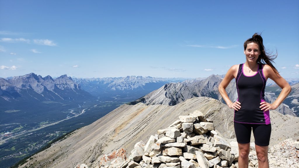 Elisha Comeau standing on Grotto Mountain Summit