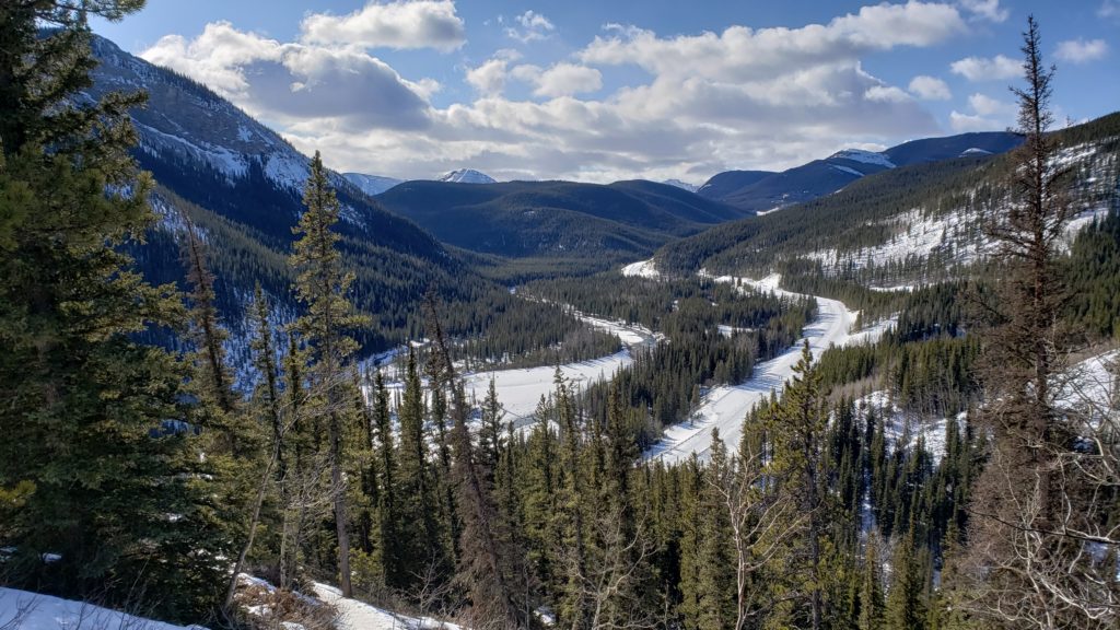 A beautiful view consisting of a valley between mountains.