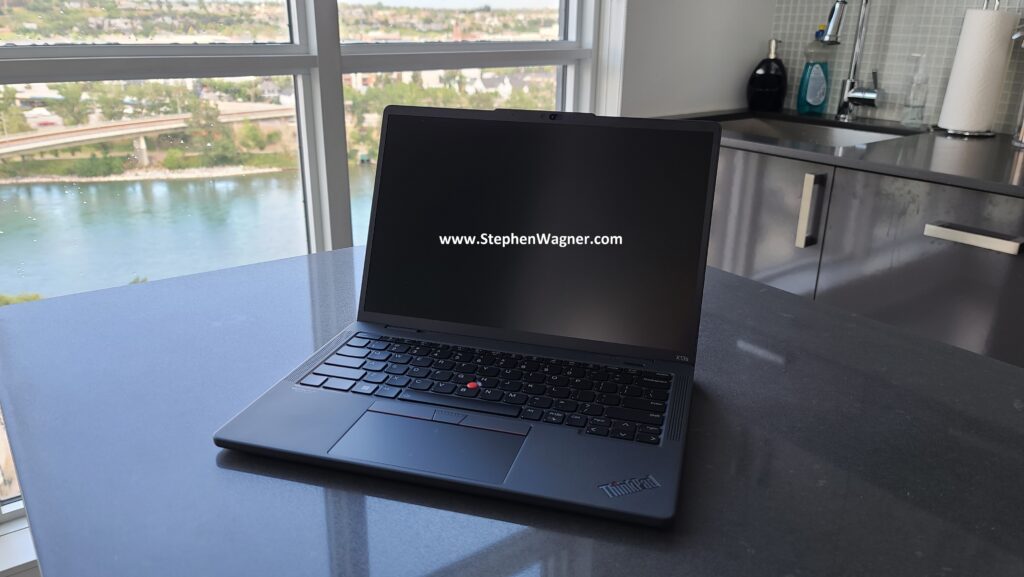 A Lenovo Thinkpad X13s laptop on counter with screen open.